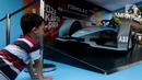 Seorang anak melihat replika mobil Formula E yang dipamerkan di Kawasan Bundaran Hotel Indonesia, Jakarta, Minggu (29/5/2022). Replika mobil balap ramah lingkungan ini dipamerkan untuk mengkampanyekan perhelatan Formula E yang akan digelar 4 Juni mendatang. (Liputan6.com/Helmi Fithriansyah)