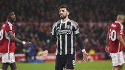 Pemain Manchester United, Bruno Fernandes, tampak kecewa setelah ditaklukkan Nottingham Forest pada laga pekan ke-20 Premier League 2023/2024, Minggu (31/12/2023) dini hari WIB. (AP Photo/Rui Vieira)