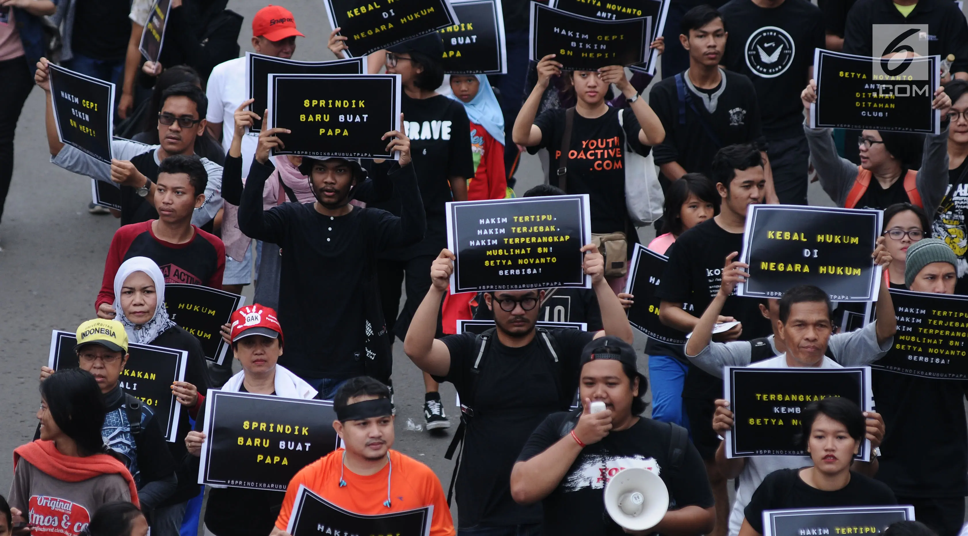 Aktivis Koalisi Masyarakat Sipil Anti Korupsi melakukan aksi jalan santai Indonesia Berkabung di kawasan Bundaran HI Jakarta, Minggu (1/10). Aksi ini reaksi menyikapi dicabutnya status tersangka Setya Novanto. (Liputan6.com/Helmi Fithriansyah)