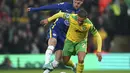 Penyerang Chelsea, Timo Werner berusaha merebut bola dari pemain Norwich City, Max Aarons pada pertandingan lanjutan Liga Inggris di di Carrow Road, Norwich, Inggris, Jumat (11/3/2022). Chelsea menang atas Norwich City 3-1. (Joe Giddens/PA via AP)