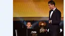 Cristiano Ronaldo didampingi anaknya, Cristiano Jr, saat menerima trofi FIFA Ballon d'Or sebagai Pemain Terbaik Dunia 2014. 12 Januari 2015. (AFP/Fabrice Coffrini)