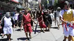 Seorang aktor yang berperan dalam sebuah drama jalanan sebagai Yesus membawa salib kayu saat peragaan penderitaan dan penyaliban pada Pekan Suci di Manila pada 28 Maret 2024. (Ted ALJIBE/AFP)