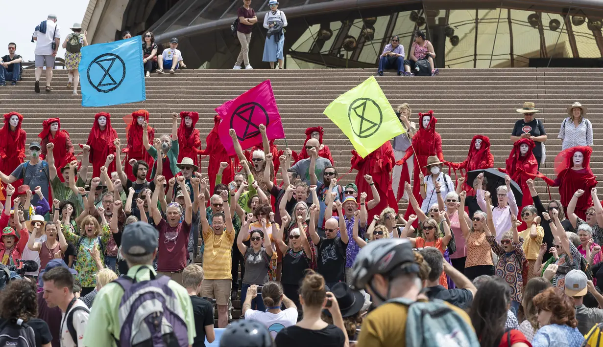 Aktivis yang terbagung dalam kelompok Red Rebels berunjuk rasa dalam demonstrasi protes iklim di Sydney (15/12/2019). Pengunjuk rasa melakukan aksi di depan landmark Gedung Opera Sydney menuntut pemerintah Australia menanggulangi asap yang menyebabkan masalah kesehatan. (AFP/Wendell Teodoro)