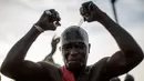 Seorang warga etnis Joles menggoreskan pisau di kepalanya saat menunjukan kekuatan sihir yang berasal dari air spiritual, yang membuat mereka kebal dari senjata tajam saat kampanye Presiden Yahya Jammeh di Bikama,Gambia (24/11). (AFP/Marco Longari)