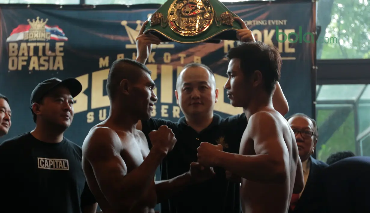 Eksprsi petinju Indonesia, Jansen Hebi Marapu (3kiri) dan lawannya petinju Thailand, Phuttinphong Rakoo saat timbang badan di Leon Restourant, Wijaya, Jakarta (09/3/2018). Jansen dan Rakoo bermain pada kelas Lightweight. (Bola.com/Nick Hanoatubun).
