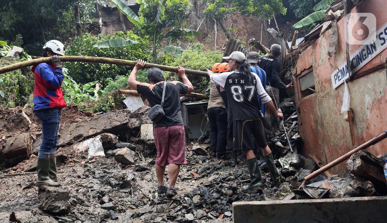 Petugas membersihkan material longsor pada areal pemancingan yang menyebabkan satu orang meninggal dunia di Gang Kepatihan, Kelurahan Kebon Kelapa, Kecamatan Bogor Tengah, Bogor, Jawa Barat, Rabu (12/10/2022). Longsor yang terjadi pada kemarin sore menyebabkan sembilan pemancing tertimbun tanah namun selamat dan seorang anggota kepolisian meninggal. (merdeka.com/Arie Basuki)
