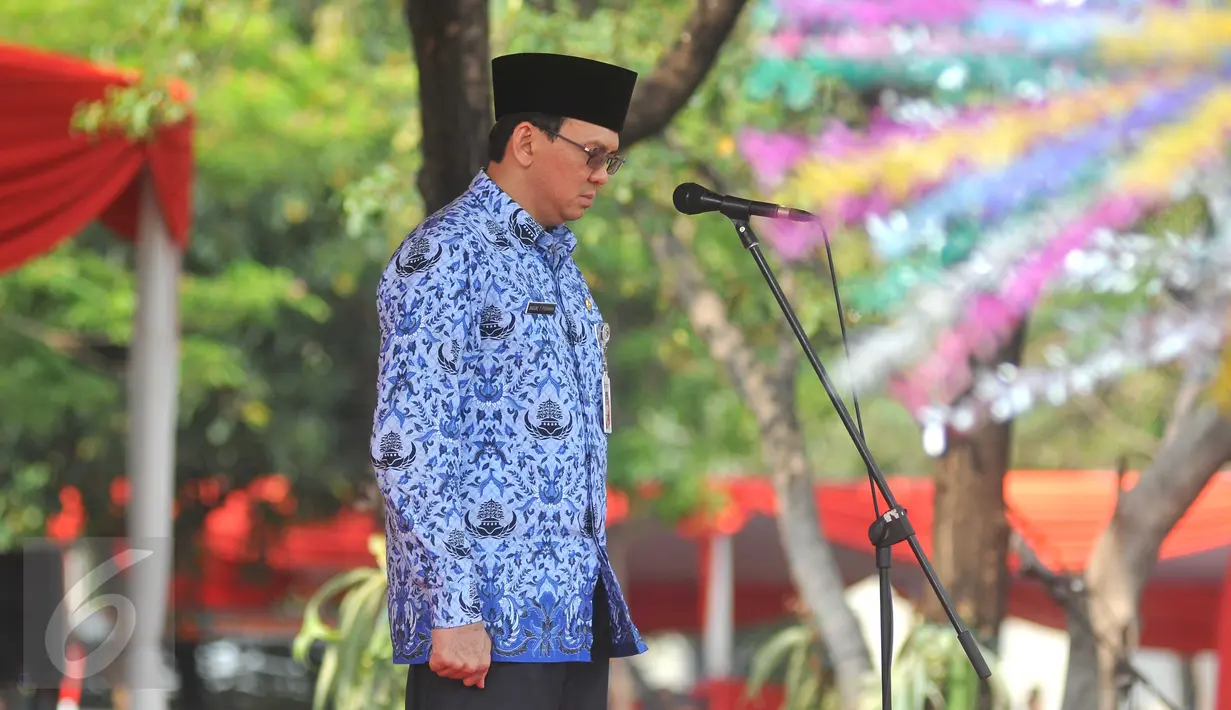 Gubernur DKI Jakarta Basuki T Purnama (Ahok) mengheningkan cipta saat memimpin upacara peringatan Hari Pahlawan di lapangan eks IRTI Monas, Jakarta, Selasa (10/11). Upacara itu diikuti  para PNS di lingkungan Pemprov DKI. (Liputan6.com/Gempur M Surya)