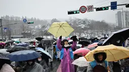 Para pengunjuk rasa bertahan di tengah hujan salju tebal di Seoul, Ibu Kota Korea Selatan, Minggu (5/1/2024), untuk menentang penangkapan Presiden Yoon Suk Yeol yang dimakzulkan. (Philip FONG/AFP)