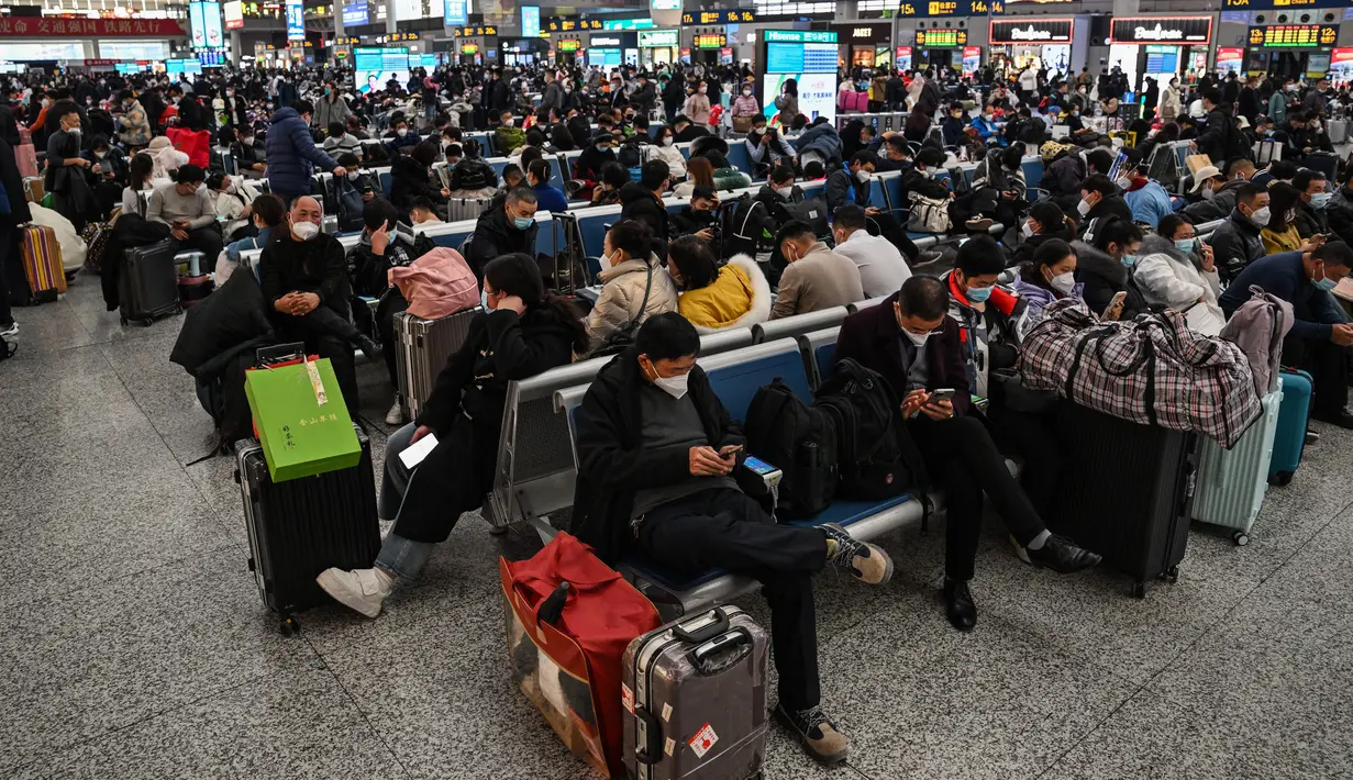 Calon penumpang menunggu kereta di Stasiun Hongqiao, Shanghai China, 11 Januari 2023. Migrasi tahunan di China dimulai dengan orang-orang kembali ke kampung halaman mereka untuk merayakan Tahun Baru Imlek. (Hector RETAMAL/AFP)