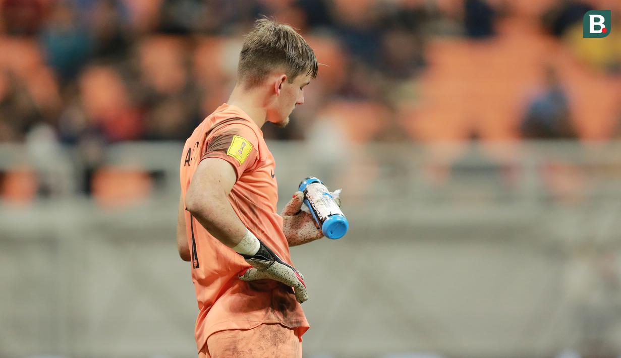Kiper Timnas Prancis U-17, Paul Argney, membaca contekan di botol minumannya saat adu penalti melawan Senegal U-17 pada babak 16 besar Piala Dunia U-17 2023 di Jakarta International Stadium (JIS), Rabu (22/11/2023). Les Bleus Muda menang 5-3 dalam adu penalti. (Bola.com/M Iqbal Ichsan)