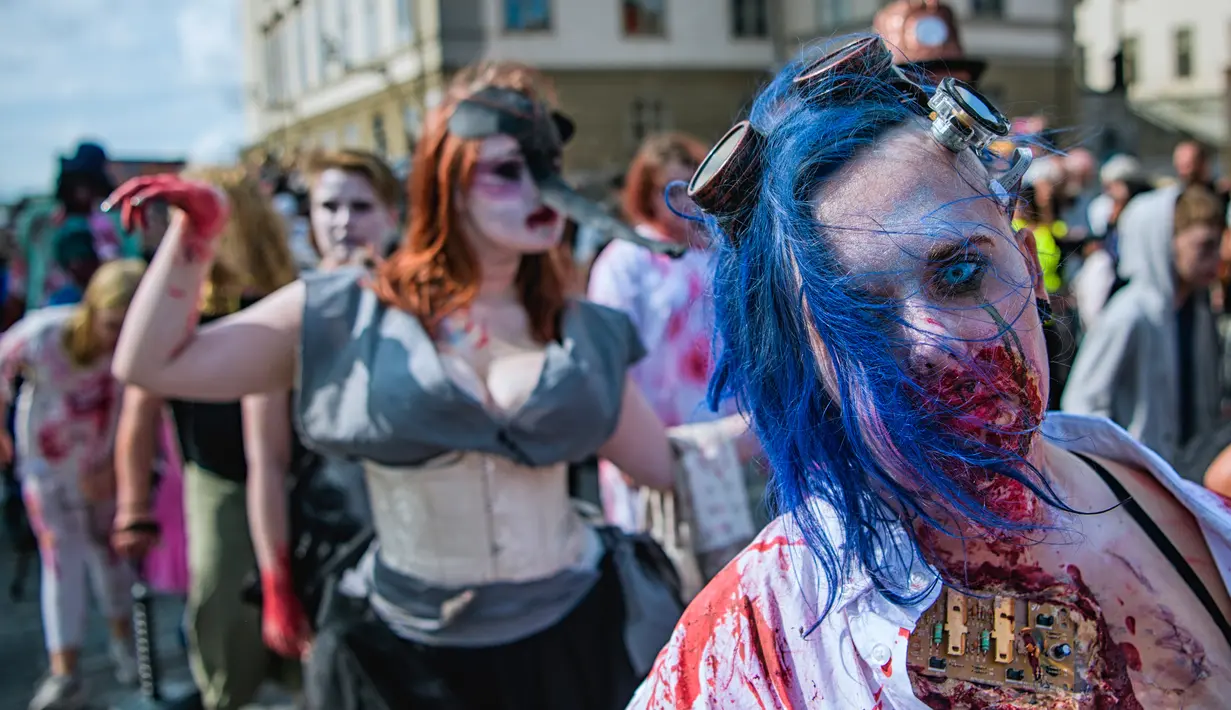 Sejumlah peserta dengan riasan zombie ikut berjalan di tengah kota dalam parade "Zombie Walk" di Stockholm, Swedia, Sabtu (19/8). Zombie Walk adalah acara yang rutin dilakukan saat musim panas tiba, tepatnya akhir Agustus. (Jonathan NACKSTRAND/AFP)