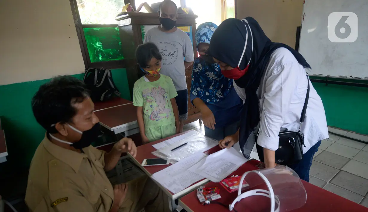 Wali murid menerima dua kartu perdana Tri dan Telkomsel beserta kuota gratis di SDN Serua Indah I dan II, Ciputat, Tangerang Selatan, Senin (15/9/2020). Program Kartu Perdana tersebut untuk mendukung kegiatan belajar secara online di masa pandemi covid-19. (merdeka.com/Dwi Narwoko)