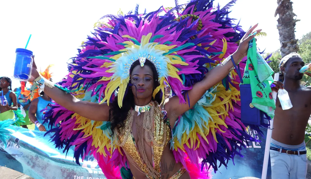 Seorang penari mengenakan kostum berpose untuk difoto sebelum mengikuti perayaan Hari Pahlawan Nasional di St. David's, Bermuda (19/6). (AFP Photo/Don Emmert)