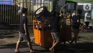 Sejumlah remaja melakukan pukul bedug keliling kampung di Karang Tengah,Tangerang, Banten, Rabu (29/4/2020). Pukul bedug keliling merupakan tradisi membangunkan warga untuk sahur pada bulan Ramadan. (Liputan6.com/Angga Yuniar)