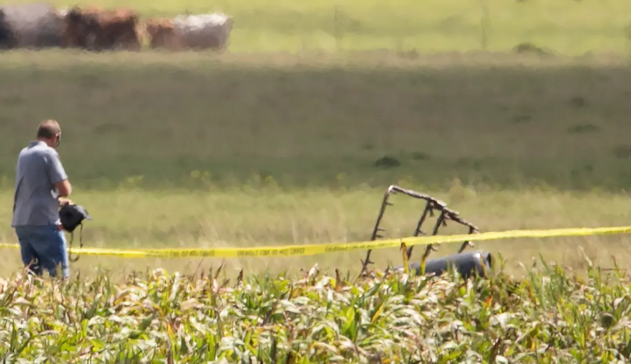 Bingkai parsial dari balon udara yang terbakar terlihat di areal padang rumput sementara penyidik melakukan penyisiran di lokasi jatuhnya balon udara tersebut, di Maxwell, wilayah Texas, Sabtu (30/7). (Ralph Barrera/Austin American-Statesman/via REUTERS)