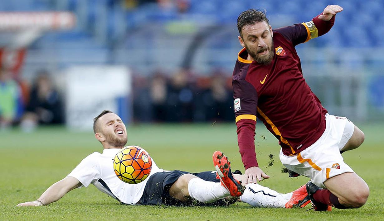Pemain AS Roma, Daniele De Rossi, terjatuh akibat tekel pemain Atalanta, Jasmin Kurtic, pada laga Serie A di Stadion Olimpico, Italia, Minggu (29/11/2015). Roma kalah 0-2. (Reuters/Giampiero Sposito) 