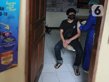 Waga menerima suntikan vaksin covid-19 Sinovac di Polsek Pamulang, Tangerang Selatan, Kamis (1/7/2021). Sebanyak 10 ribu dosis vaksin untuk warga 18 tahun ke atas dibagikan di wilayah Polres Tangerang Selatan dalam rangka HUT Bhayangkara Ke-75 yang jatuh pada hari ini. (merdeka.com/Arie Basuki)