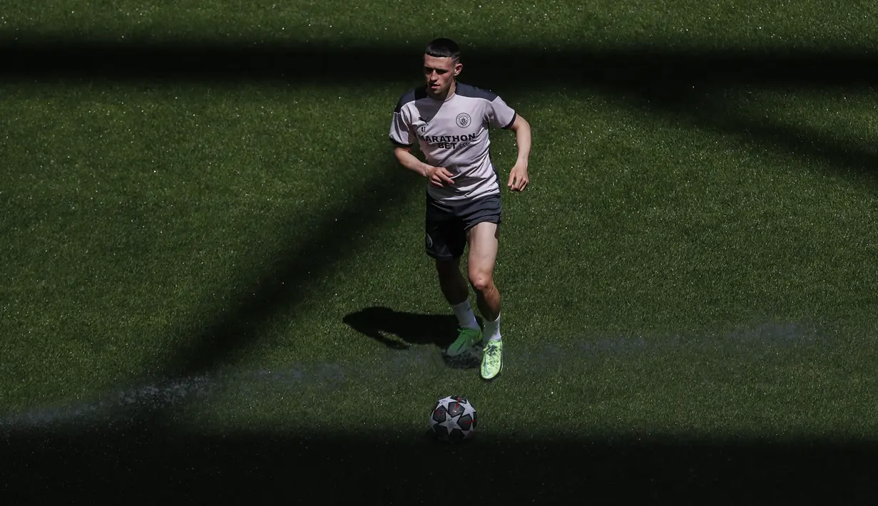 Gelandang Manchester City, Phil Foden membawa bola saat latihan di stadion Dragao di Porto, Portugal, Jumat (28/5/2021). Bagi City, kemenangan skuad Pep Guardiola dalam duel City vs Chelsea akan membuat mereka mencetak sejarah menjuarai Liga Champions untuk pertama kalinya. (Susana Vera/Pool via AP)