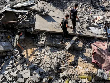 Orang-orang berjalan di antara puing-puing setelah serangan Israel di Jabalia, Jalur Gaza Utara pada 27 Juni 2025. (Omar AL-QATTAA/AFP)
