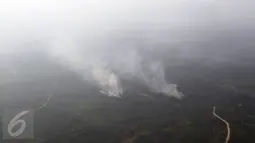 Asap mengepul dari sejumlah titik api yang membakar hutan di wilayah Kaimantan Timur, Selasa (27/10). Kabut asap yang menyelimuti Kalimantan mulai berkurang dikarenakan beberapa wilayah sumber asap telah turun hujan. (Liputan6.com/Immanuel Antonius)