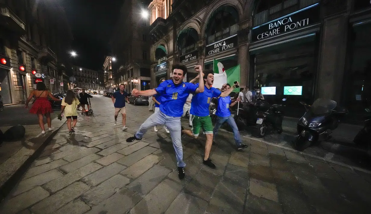 Suporter merayakan kemenangan Italia atas Inggris pada pertandingan final Euro 2020 di Milan, Italia, Senin (12/7/2021). Italia menjuarai Euro 2020 usai mengalahkan Inggris lewat drama adu penalti pada pertandingan final. (AP Photo/Luca Bruno)