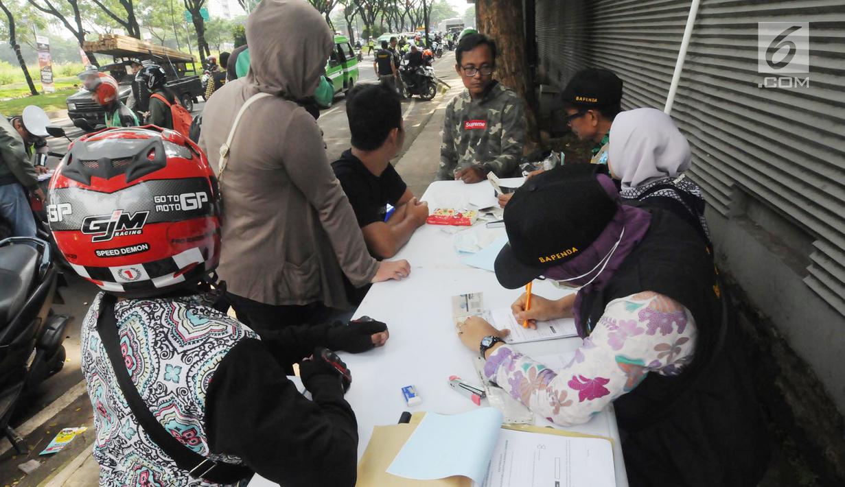 Anggota Satlantas Polres Tangerang Selatan memeriksa kelengkapan surat saat razia pajak kendaraan di Jalan BSD, Tangerang Selatan, Kamis (24/1). Razia ini untuk mendisiplinkan pengendara terhadap pembayaran pajak kendaran. (Merdeka.com/Arie Basuki)