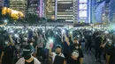 Mahasiswa menyalakan ponselnya sambil menyanyikan 'Do You Hear the People Sing' dari 'Les Miserables' selama rapat umum di Hong Kong (22/8/2019). Boikot ini disebabkan karena masa perkuliahan mendatang waktunya bertabrakan dengan unjuk rasa massa pro-demokrasi. (AFP Photo/Anthony Wallace)