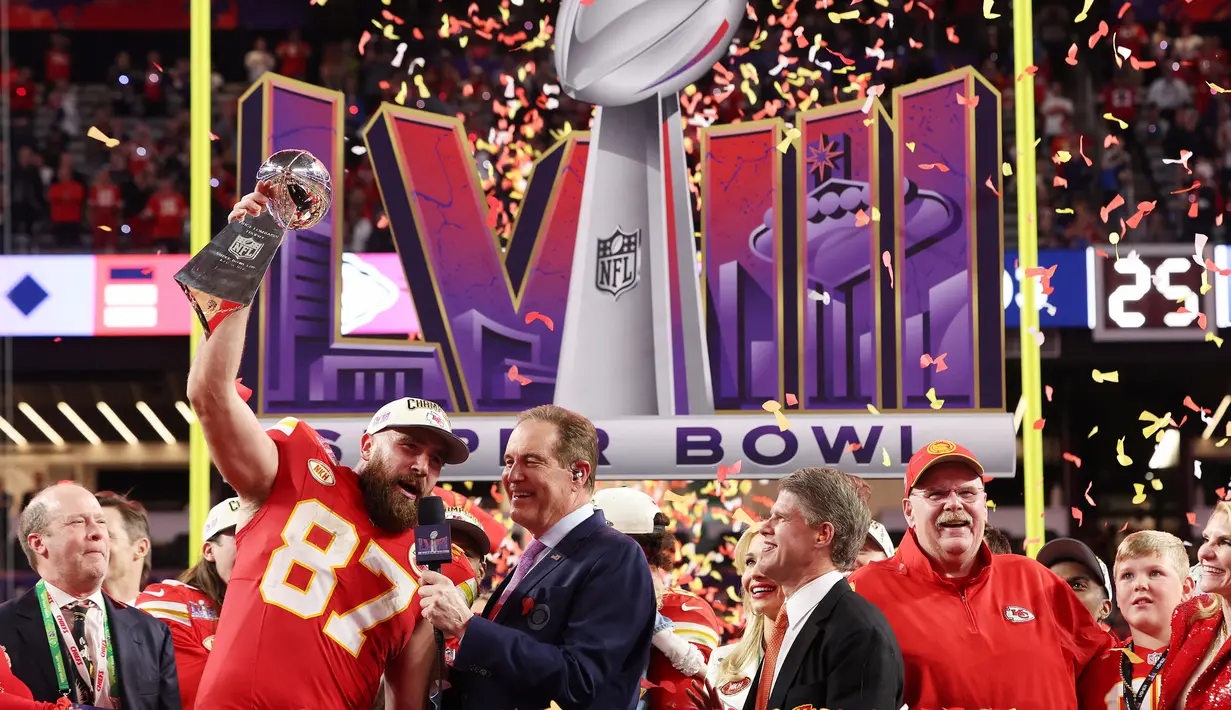 Kapten Kansas City Chiefs, Travis Kelce mengangkat trofi Super Bowl  LVIII setelah mengalahkan San Francisco 49ers di Las Vegas, Amerika Serikat, Minggu (11/02/2024) waktu setempat. (AFP/Jamie Squire)