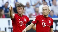 SELEBRASI - Thomas Muller berpelukan dengan Arjen Robben usai mencetak gol ke gawang Hoffenheim. (REUTERS/Ralph Orlowski)