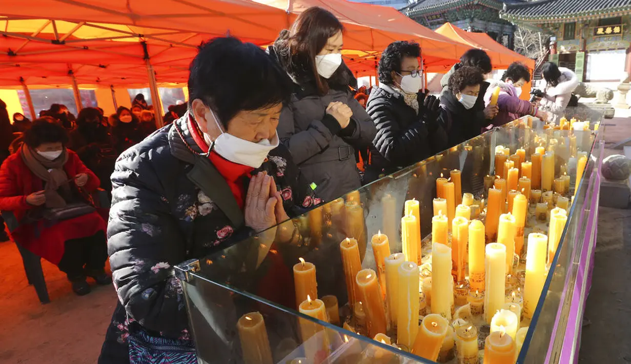 Para orangtua berdoa selama kebaktian khusus untuk mendoakan keberhasilan anak-anak mereka dalam ujian masuk perguruan tinggi di Kuil Buddha Jogyesa, Seoul, Korea Selatan, Kamis (3/12/2020). Ujian diikuti ratusan ribu siswa, termasuk puluhan siswa pasien COVID-19. (AP Photo/Ahn Young-joon)