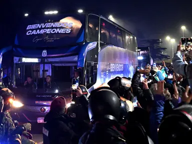 Para penggemar mengambil gambar bus yang mengangkut tim sepak bola nasional Argentina di Ezeiza, Buenos Aires, Argentina pada 15 Juli 2024. (Luis ROBAYO/AFP)