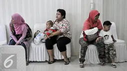 Sejumlah warga menunggu giliran untuk konsultasi dan vaksinasi ulang di RS Polri Kramatjati, Jakarta Timur, Kamis (21/7). RS Polri Kramatjati buka posko pelayan vaksinasi ulang untuk warga. (Liputan6.com/Yoppy Renato)