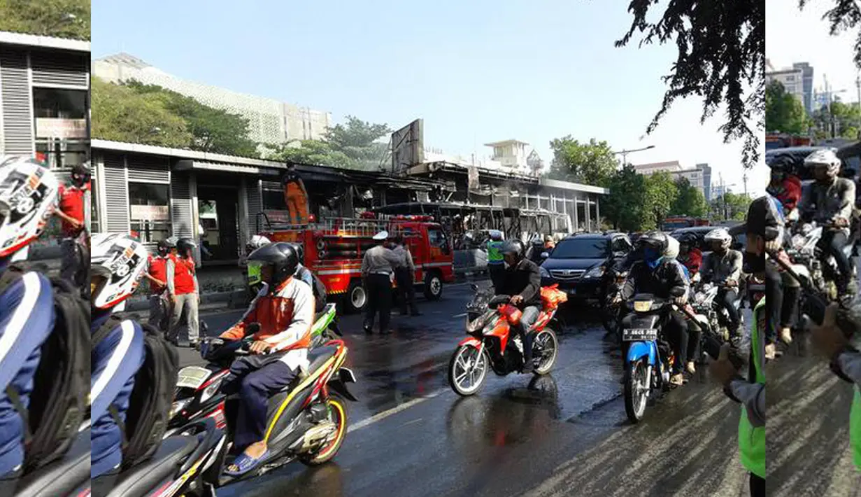 Tampak petugas pemadam kebakaran masih berada di lokasi untuk menyirami bus yang masih dalam kondisi berasap tersebut. Sebuah bus Transjakarta terbakar di kawasan Salemba, Jakarta Pusat, Jumat (3/7/2015). (twitter.com/FaisalRizalical)