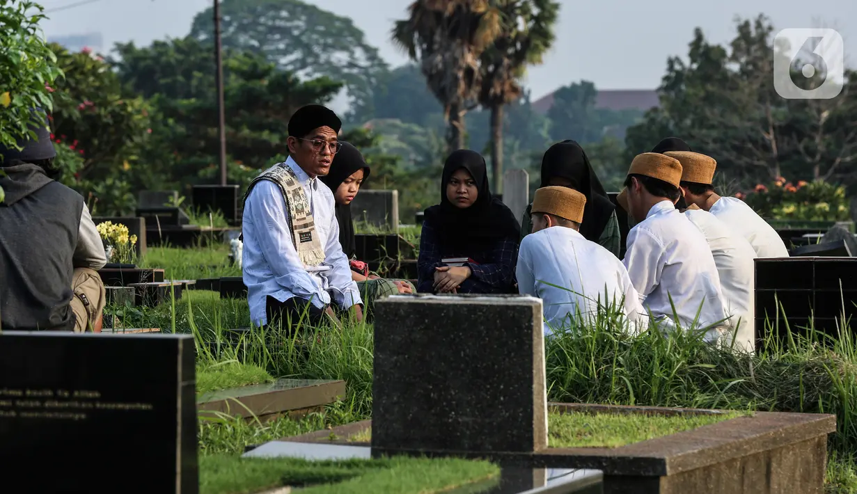 Warga berziarah di makam keluarganya di Tempat Pemakaman Umum (TPU) Tanah Kusir, Jakarta, Selasa (29/3/2022). TPU setempat semakin banyak dikunjungi warga yang melakukan tradisi ziarah kubur menjelang Ramadhan. (Liputan6.com/Johan Tallo)