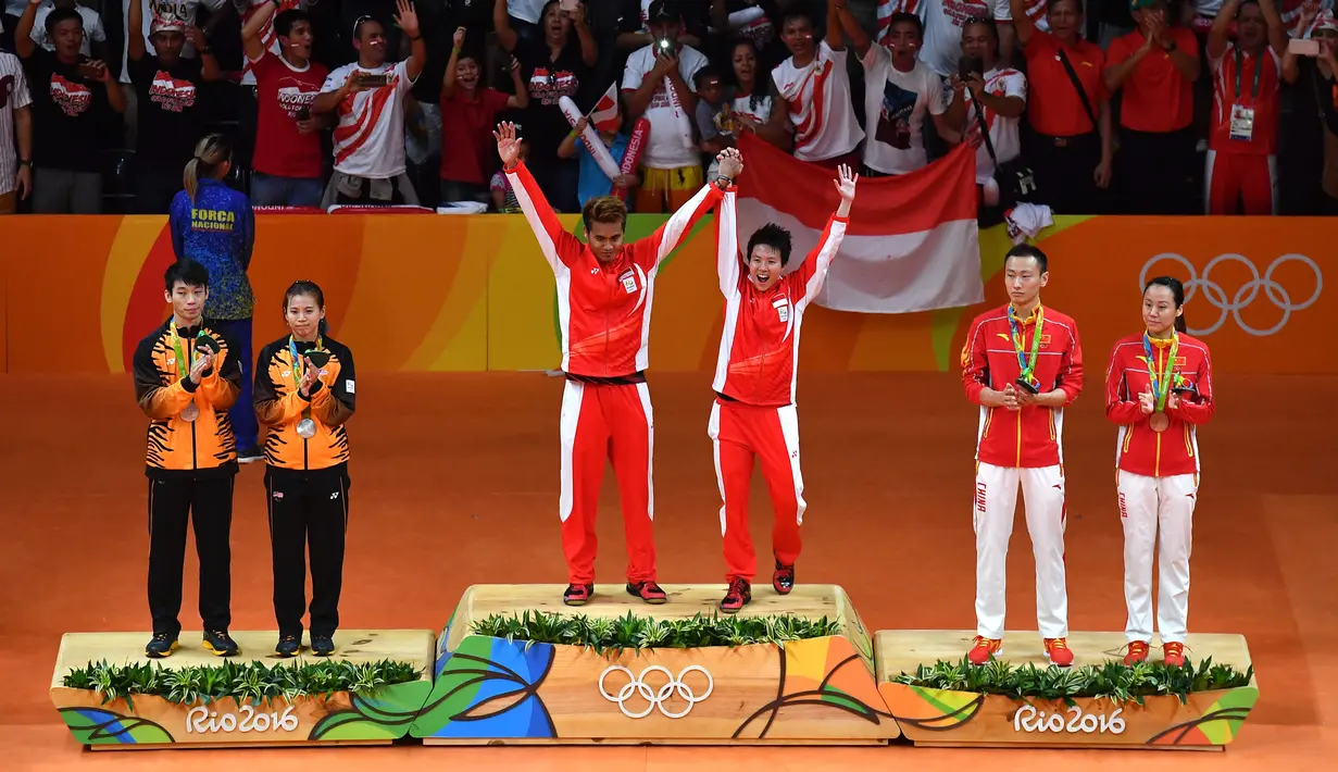 Peraih emas badminton ganda campuran Indonesia Tontowi Ahmad/Liliyana Natsir (tengah), peraih perak Malaysia Liu Ying Goh/Peng Soon Chan, peraih perunggu China Zhang Nan/Zhao Yunlei berdiri di podium Olimpiade Rio 2016, Stadion Riocentro, Rio de Janeiro, Brasil, 17 Agustus 2016. (BEN STANSALL/AFP)