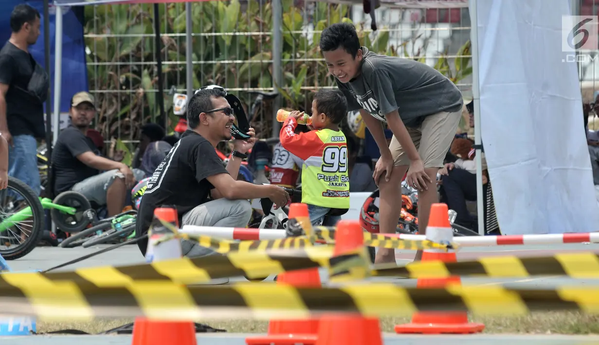 Pembalap balita meminum minuman saat mengikuti kejuaraan sepeda kategori Push Bike dalam BMX Bearco Fest 2019 di Jakarta International BMX Track, Minggu (25/8/2019). Kejuaraan yang pesertanya menggunakan sepeda keseimbangan tersebut diikuti 105 anak dari berbagai daerah. (merdeka.com/Iqbal Nugroho)