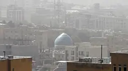 Badai pasir melanda sebuah masjid di ibu kota Iran, Teheran pada 17 Mei 2022. Kantor-kantor pemerintah, serta sekolah dan universitas diumumkan ditutup di banyak provinsi di Iran karena kondisi "cuaca tidak sehat" dan badai pasir yang menyelimuti, menurut laporan media pemerintah. (AFP)