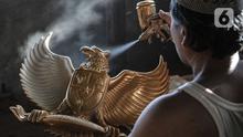 Perajin menyelesaikan proses pewarnaan patung Garuda Pancasila di industri rumahan di Jalan Bali Raya, Jakarta, Kamis (1/10/2020). Perajin menjual patung Garuda Pancasila dengan harga yang dijual berkisar Rp100 ribu-Rp125 ribu per buah. (merdeka.com/Iqbal S. Nugroho)