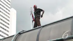 Seorang pria nekat melakukan aksi di atap jembatan penyeberangan orang (JPO) di Jl MH Thamrin, Jakarta Pusat (Liputan6.com/Johan Tallo)
