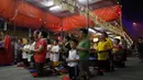 Menurut Tao dan keyakinan Budha, bulan ketujuh dalam kalender Imlek Tiongkok dikenal sebagai festival Hungry Ghost. Beberapa warga keturunan Tiongkok berdoa saat festival Hungry Ghost, (3/8/2014). (REUTERS/Olivia Harris)