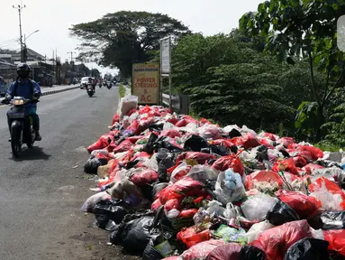 Tumpukan sampah menumpuk didekat Pasar Induk Cikema, Jalan Raya Bogor, Kabupaten Bogor, Senin (1/6/2020). Minimnya lokasi penampungan sampah semenatara dan kesadaran warga untuk membuang sampah pada tempatnya menjadikan area ini kerap dipenuhi timbunan sampah. (Liputan6.com/Helmi Fihtriansyah)