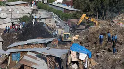 Alat berat dikerahkan untuk mencari korban longsoran sampah di luar ibu kota Ethiopia, Addis Ababa, Minggu (12/3). Gundukan besar sampah di tempat pembuangan Koshe longsor hari Sabtu dan meratakan puluhan rumah di dekatnya. (Zacharias ABUBEKER/AFP)