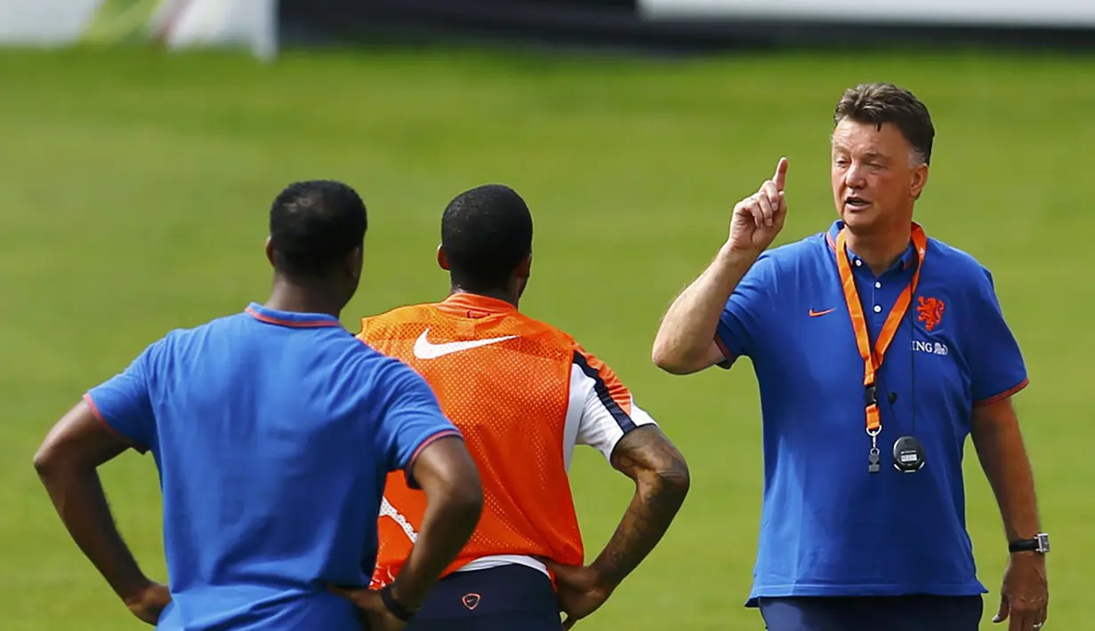 Pelatih Timnas Belanda, Louis van Gaal (kanan), memberikan instruksi langsung pada dua pemainnya saat berlatih di Rio de Janeiro, (2/7/2014). (REUTERS/Pilar Olivares)