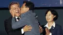 Kandidat Presiden Korsel, Moon Jae-in mendapat kecupan dari Gubernur Provinsi Chungcheong, Ahn Hee-jung sebelum menyampaikan pidato kemenangannya di Seoul, Selasa (9/5). Moon menang telak dengan megantongi 41,4 persen suara. (AP Photo/Ahn Young-joon)