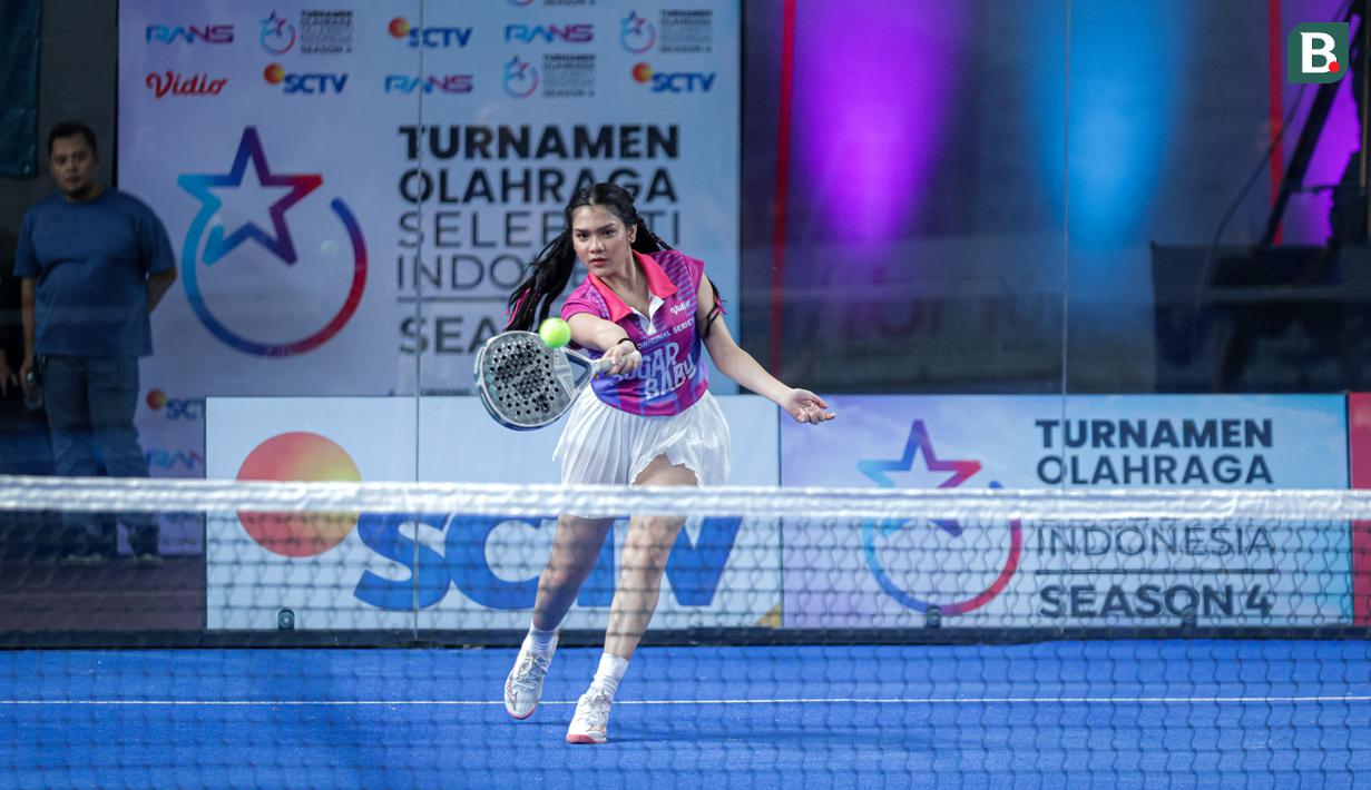 Selebritas Indonesia, Davina Karamoy memukul bola ke lawan dalam laga semifinal ganda campuran padel Turnamen Olahraga Selebriti Indonesia (TOSI) Season 4 di GOR UNJ, Jakarta, Minggu (02/11/2025). (Bola.com/Bagakara Lazuardi)