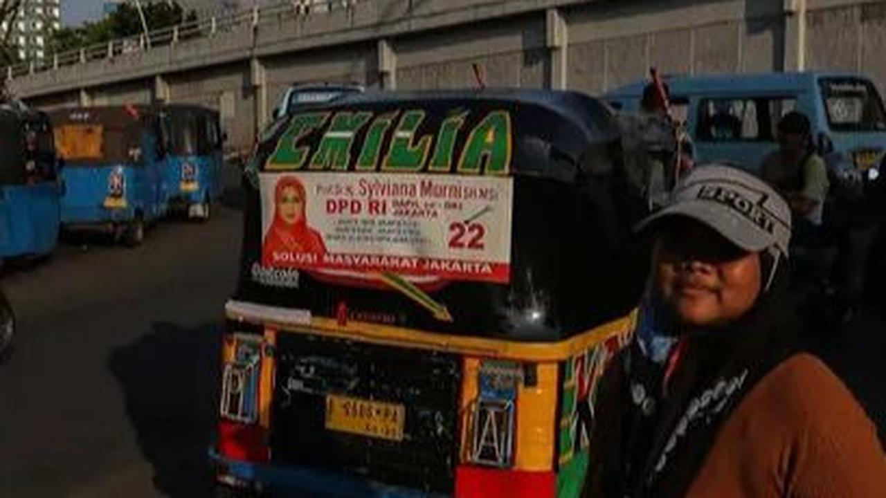 Alat Peraga Kampanye (APK) terpasang pada kaca bagian belakang sebuah bajaj di kawasan Tanah Abang, Jakarta, Jumat (5/1/2024). Jelang Pemilu 2024, semakin banyak APK dengan wajah para politikus terpasang di angkutan umum. perkotaan.