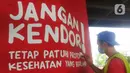 Mahasiswa melukis mural bertemakan sosialisasi pencegahan Covid-19 di kolong jalan tol dalam kota, Kebun Nanas, Jakarta, Jumat (4/12/2020). Kegiatan membuat mural ini dalam rangka mengkampanyekan pola hidup sehat 3m. (merdeka.com/Arie Basuki)