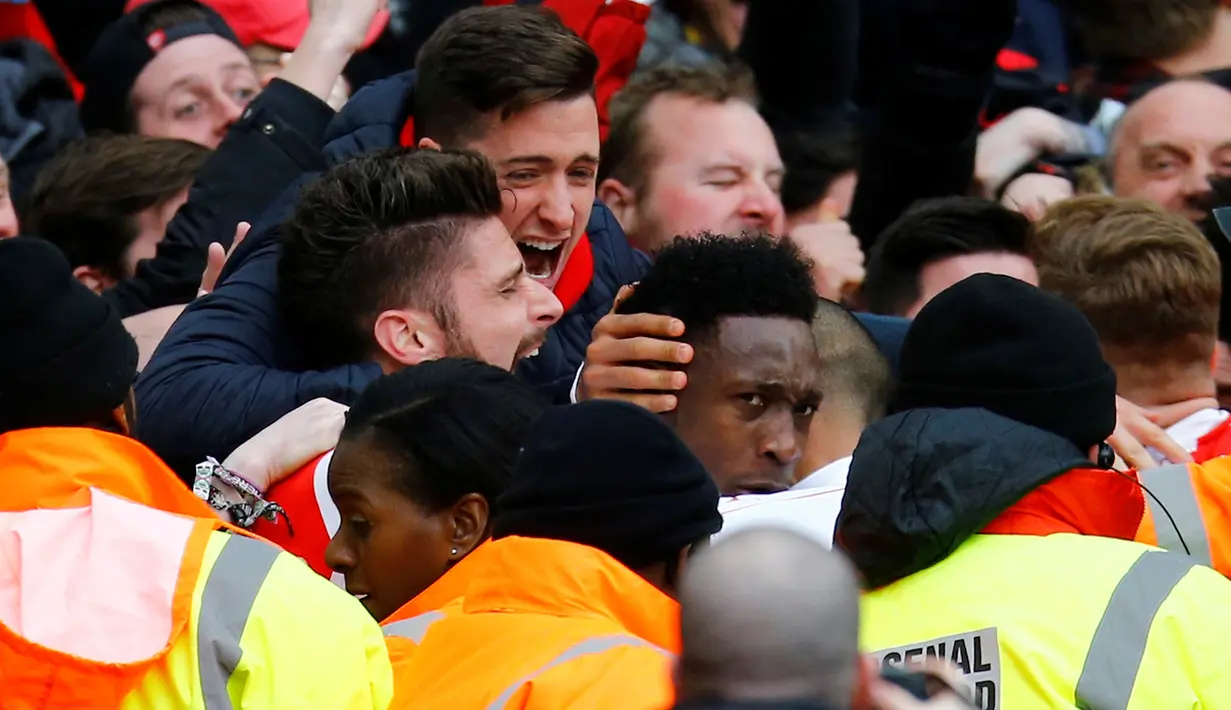 Striker Arsenal, Danny Welbeck, disambut rekan-rekannya setelah mencetak gol ke gawang Leicester City di menit akhir dalam laga Liga Inggris di Stadion Emirates, London, Minggu (14/2/2016). (Reuters/Darren Staples)
