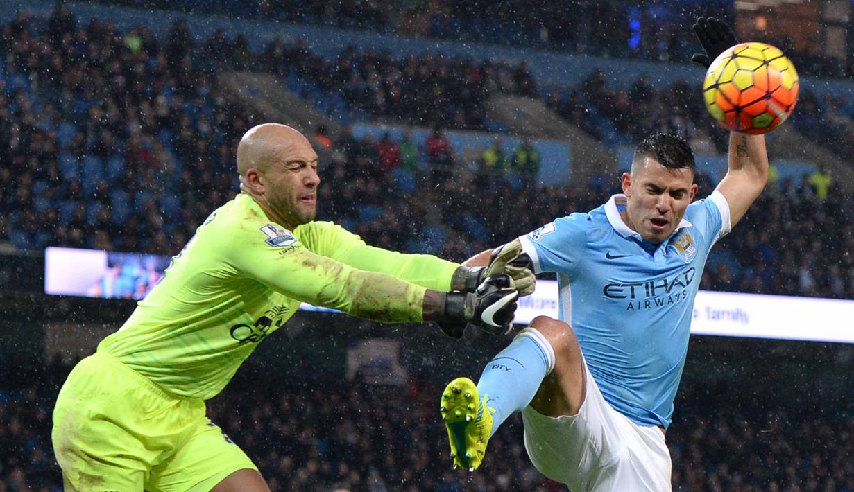 Pemain Manchester City, Sergio Aguero (kanan) melakukan tembakan saat dihadang kiper Everton Tim Howard pada lanjutan Liga Premier Inggris di Stadion Etihad, Manchester, Kamis (14/1/2016) dini hari WIB. (AFP Photo/Oli Scarff)