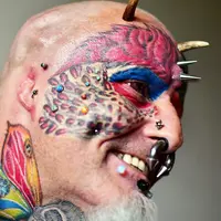 Untuk membuat dirinya mirip dengan burung beo, dia bahkan memiliki 110 tato, 50 'piercing,' dan bahkan membelah lidahnya!